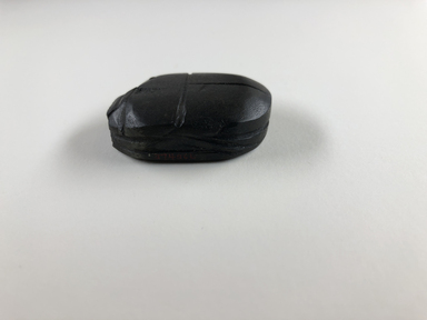  <em>Heart Scarab</em>, ca. 1292-1075 B.C.E. Basalt, 1/2 x 1 9/16 x 1 1/4 in. (1.3 x 4 x 3.2 cm). Brooklyn Museum, Charles Edwin Wilbour Fund, 37.486E. Creative Commons-BY (Photo: , CUR.37.486E_view01.jpg)