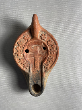  <em>Lamp</em>, 4th-5th century C.E. Clay, 3 7/16 × 1 3/4 × 5 13/16 in. (8.8 × 4.5 × 14.8 cm). Brooklyn Museum, Gift of Marvin Chauncey Ross, 37.524. Creative Commons-BY (Photo: Brooklyn Museum, CUR.37.524_view01.jpeg)