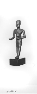  <em>Small Figure of a Priest Walking</em>, 664-332 B.C.E. Bronze, 3 1/16 x 1 7/16 x 13/16 in. (7.8 x 3.6 x 2.1 cm). Brooklyn Museum, Charles Edwin Wilbour Fund, 37.552E. Creative Commons-BY (Photo: Brooklyn Museum, CUR.37.552E_NegID_37.552E_GRPA_print_cropped_bw.jpg)