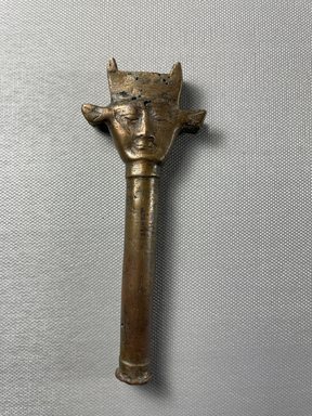  <em>Sistrum Handle</em>, 305-30 B.C.E. Bronze, 5 1/16 x 1 15/16 x 1/2 in. (12.8 x 5 x 1.2 cm). Brooklyn Museum, Charles Edwin Wilbour Fund, 37.584E. Creative Commons-BY (Photo: Brooklyn Museum, CUR.37.584E_view01.jpg)