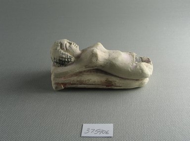  <em>Small Figure of a Woman Lying on a Couch</em>, 305–30 B.C.E. Limestone, pigment, 1 13/16 x 1 9/16 x 3 5/8 in. (4.6 x 3.9 x 9.2 cm). Brooklyn Museum, Charles Edwin Wilbour Fund, 37.590E. Creative Commons-BY (Photo: Brooklyn Museum, CUR.37.590E_view4.jpg)