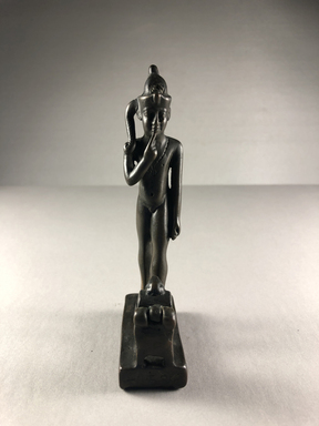  <em>Figure of the Child Horus Standing in Front of a Small Box with Moveable Cover</em>, 664–332 B.C.E. Bronze, 5 3/16 × 1 1/8 × 2 3/8 in. (13.1 × 2.8 × 6.1 cm). Brooklyn Museum, Charles Edwin Wilbour Fund, 37.593E. Creative Commons-BY (Photo: , CUR.37.593E_view01.jpg)