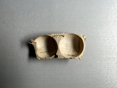  <em>Small Double Toilet Dish with Two Circular Receptacles</em>, ca. 1539-1292 B.C.E. Ivory, 11/16 × 1 11/16 × 3 11/16 in. (1.8 × 4.3 × 9.3 cm). Brooklyn Museum, Charles Edwin Wilbour Fund, 37.603E. Creative Commons-BY (Photo: Brooklyn Museum, CUR.37.603E_overall01.JPG)