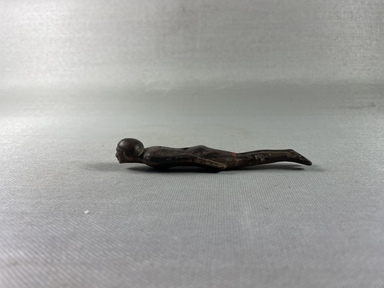  <em>Handle of a Toilet Dish in the Form of a Floating Man</em>, ca. 1539-1292 B.C.E. Wood, 1/2 × 13/16 × 4 1/8 in. (1.3 × 2.1 × 10.5 cm). Brooklyn Museum, Charles Edwin Wilbour Fund, 37.607E. Creative Commons-BY (Photo: Brooklyn Museum, CUR.37.607E_view01.jpg)