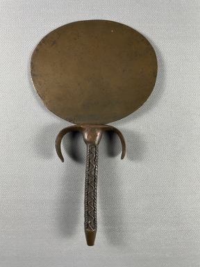  <em>Mirror with Handle Decorated with Braid and Wavy Lines</em>, ca. 1539-1292 B.C.E. Bronze, 7 15/16 × 4 5/8 × 3 3/4 in. (20.1 × 11.7 × 9.5 cm). Brooklyn Museum, Charles Edwin Wilbour Fund, 37.639E. Creative Commons-BY (Photo: Brooklyn Museum, CUR.37.639E_view01.jpg)