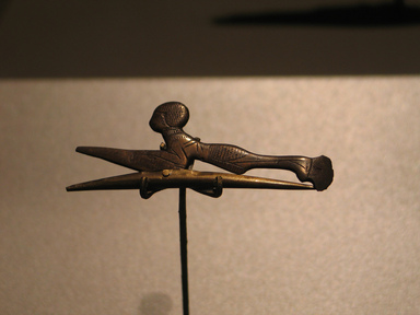 Egyptian. <em>Hair Curler in the Form of  a Woman</em>, ca. 1539-1292 B.C.E. Bronze, 7/8 x 2 5/16 in. (2.2 x 5.9 cm). Brooklyn Museum, Charles Edwin Wilbour Fund, 37.654E. Creative Commons-BY (Photo: Brooklyn Museum, CUR.37.654E_erg456.jpg)