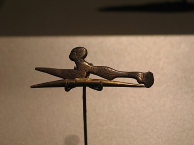 Egyptian. <em>Hair Curler in the Form of  a Woman</em>, ca. 1539–1292 B.C.E. Bronze, 7/8 x 2 5/16 in. (2.2 x 5.9 cm). Brooklyn Museum, Charles Edwin Wilbour Fund, 37.654E. Creative Commons-BY (Photo: Brooklyn Museum, CUR.37.654E_erg456.jpg)