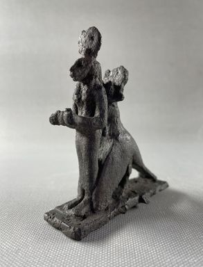  <em>Group of the Goddess Sekhmet Standing Surmounted by the Sun Disk within the Embrace of a Jackal - Headed Bird</em>, 664-332 B.C.E. Bronze, 3 7/16 × 1 × 3 in. (8.7 × 2.5 × 7.6 cm). Brooklyn Museum, Charles Edwin Wilbour Fund, 37.689E. Creative Commons-BY (Photo: Brooklyn Museum, CUR.37.689E_view01.jpg)