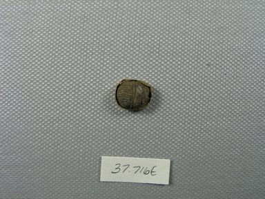  <em>Small Scarab Amulet</em>, 305-30 B.C.E. Lapis lazuli, gold, 3/16 x 7/16 x 7/16 in. (0.6 x 1.1 x 1.1 cm). Brooklyn Museum, Charles Edwin Wilbour Fund, 37.716E. Creative Commons-BY (Photo: Brooklyn Museum, CUR.37.716E_view1.jpg)