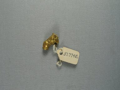  <em>Part of a Earring in the Form of a Bull's Head</em>, 3rd century B.C.E. Gold, 3/16 x 13/16 in. (0.5 x 2 cm). Brooklyn Museum, Charles Edwin Wilbour Fund, 37.779E. Creative Commons-BY (Photo: Brooklyn Museum, CUR.37.779E_view1.jpg)