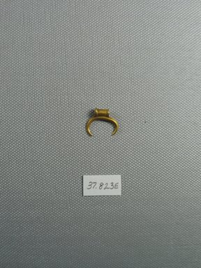  <em>Amulet in the Form of a Crescent</em>, 2nd–1st century B.C.E. Gold, 9/16 x 3/16 x 11/16 in. (1.5 x 0.5 x 1.7 cm, 1.35 g). Brooklyn Museum, Charles Edwin Wilbour Fund, 37.823E. Creative Commons-BY (Photo: Brooklyn Museum, CUR.37.823E_view1.jpg)