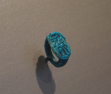  <em>Signet Ring Bearing Cartouche of Tutankhamun</em>, ca. 1329-1322 B.C.E. Faience, 13/16 × 1/2 × 3/4 in. (2 × 1.2 × 1.9 cm). Brooklyn Museum, Charles Edwin Wilbour Fund, 37.889E. Creative Commons-BY (Photo: Brooklyn Museum, CUR.37.889E_erg456.jpg)
