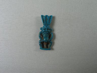  <em>Bes Amulet</em>, ca. 1075–656 B.C.E. Faience, 1 7/8 x 3/4 x 5/16 in. (4.7 x 1.9 x 0.8 cm). Brooklyn Museum, Charles Edwin Wilbour Fund, 37.927E. Creative Commons-BY (Photo: Brooklyn Museum, CUR.37.927E_view01.jpg)