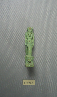  <em>Figure of Nefertum</em>, 664–343 B.C.E. Faience, 2 15/16 x 3/4 x 1 3/8 in. (7.5 x 1.9 x 3.5 cm). Brooklyn Museum, Charles Edwin Wilbour Fund, 37.945E. Creative Commons-BY (Photo: Brooklyn Museum, CUR.37.945E_view01.jpg)