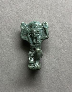  <em>Shu Amulet</em>, 664-332 B.C.E. Faience, 15/16 x 1/2 x 3/8 in. (2.4 x 1.3 x 1 cm). Brooklyn Museum, Charles Edwin Wilbour Fund, 37.955E. Creative Commons-BY (Photo: , CUR.37.955E_view01.jpg)