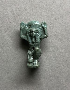  <em>Shu Amulet</em>, 664–332 B.C.E. Faience, 15/16 x 1/2 x 3/8 in. (2.4 x 1.3 x 1 cm). Brooklyn Museum, Charles Edwin Wilbour Fund, 37.955E. Creative Commons-BY (Photo: , CUR.37.955E_view01.jpg)