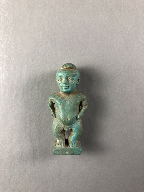  <em>Amulet of Pataikos</em>, 664-332 B.C.E. Faience, 1 15/16 × 7/8 × 11/16 in. (5 × 2.3 × 1.8 cm). Brooklyn Museum, Charles Edwin Wilbour Fund, 37.986E. Creative Commons-BY (Photo: , CUR.37.986E_view01.jpg)