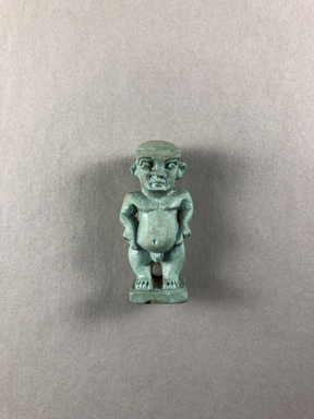  <em>Amulet of Pataikos</em>, 664–332 B.C.E. Faience, 1 1/2 × 11/16 × 1/2 in. (3.8 × 1.8 × 1.3 cm). Brooklyn Museum, Charles Edwin Wilbour Fund, 37.988E. Creative Commons-BY (Photo: , CUR.37.988E_view01.jpg)