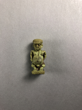  <em>Amulet of Pataikos</em>, 664–332 B.C.E. Faience, 1 5/16 × 5/8 × 7/16 in. (3.3 × 1.6 × 1.1 cm). Brooklyn Museum, Charles Edwin Wilbour Fund, 37.990E. Creative Commons-BY (Photo: , CUR.37.990E_view01.jpg)