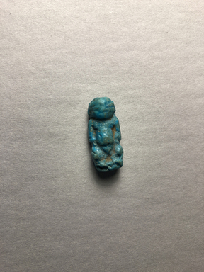  <em>Amulet of Pataikos</em>, 664-332 B.C.E. Faience, 1 × 7/16 × 5/16 in. (2.5 × 1.1 × 0.8 cm). Brooklyn Museum, Charles Edwin Wilbour Fund, 37.993E. Creative Commons-BY (Photo: , CUR.37.993E_view01.jpg)