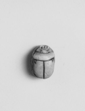 Egyptian. <em>Motto Scarab</em>, ca. 1352-1336 B.C.E. Faience, 3/16 x 1/4 x 5/16 in. (0.4 x 0.6 x 0.8 cm). Brooklyn Museum, Gift of the Egypt Exploration Society, 38.546. Creative Commons-BY (Photo: Brooklyn Museum, CUR.38.546_neg44.123.115_grpA_print_cropped_bw.jpg)