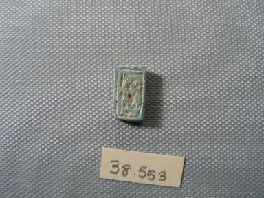 Nubian. <em>Scaraboid or Plaque</em>, ca. 1352–1336 B.C.E. Faience, 3/8 × 3/16 × 5/8 in. (0.9 × 0.5 × 1.6 cm). Brooklyn Museum, Gift of the Egypt Exploration Society, 38.553. Creative Commons-BY (Photo: , CUR.38.553_view01.jpg)