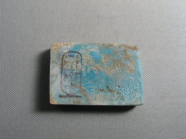 Nubian. <em>Plaque</em>, ca. 1352–1336 B.C.E. Faience, 1 13/16 × 2 11/16 × 3/8 in. (4.6 × 6.8 × 0.9 cm). Brooklyn Museum, Gift of the Egypt Exploration Society, 38.555. Creative Commons-BY (Photo: , CUR.38.555_view01.jpg)