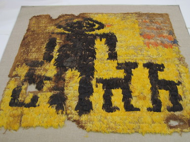 Possibly Chimú. <em>Tunic, Fragment or Tabard?</em>, 600-1000 C.E. Cotton, feathers, 20 × 24 in. (50.8 × 61 cm). Brooklyn Museum, Henry L. Batterman Fund, 41.522.1. Creative Commons-BY (Photo: , CUR.41.522.1.jpg)