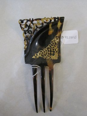  <em>Hair Comb</em>. Tortoise shell, metal, 2 1/4 x 5 1/2 in. (5.7 x 14 cm). Brooklyn Museum, Gift of Mrs. James Dowd Lester

, 42.221.35 (Photo: Brooklyn Museum, CUR.42.221.35.jpg)