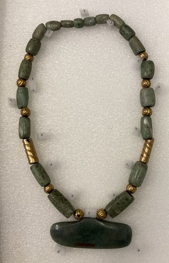  <em>Necklace</em>. Jade, gold, mordern cord, 9 × 5 1/4 × 3/16 in. (22.9 × 13.3 × 0.5 cm). Brooklyn Museum, Museum Expedition 1942, Frank L. Babbott Fund, 42.235.34. Creative Commons-BY (Photo: Brooklyn Museum, CUR.42.235.34.jpg)