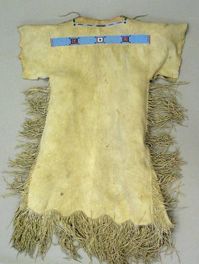 Cheyenne. <em>Woman's Dress</em>, 20th century. Elk skin, beads, 50 1/4 x 37 in. (127.6 x 94 cm). Brooklyn Museum, Gift of Mrs. Percy Jackson, 43.156.1. Creative Commons-BY (Photo: Brooklyn Museum, CUR.43.156.1_view1.jpg)