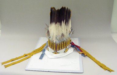 Probably Sioux. <em>Headdress or Feather Bonnet</em>, 20th century. Hide, feathers, beads, ribbon, flannel, pigment, approximate: 19 x 9 x 7 in. (48.3 x 22.9 x 17.8 cm). Brooklyn Museum, Gift of Mrs. Percy Jackson, 43.156.6. Creative Commons-BY (Photo: Brooklyn Museum, CUR.43.156.6_view1.jpg)