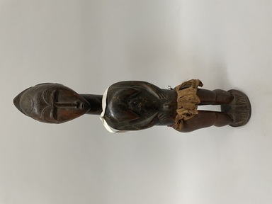 Baule. <em>Female Figure</em>, early 20th century. Wood, fiber, beads, 17 1/8 x 3 15/16 x 3 11/16in. (43.5 x 10 x 9.3cm). Brooklyn Museum, Gift of Arthur Wiesenberger, 43.177.26. Creative Commons-BY (Photo: Brooklyn Museum, CUR.43.177.26_overall.jpeg)