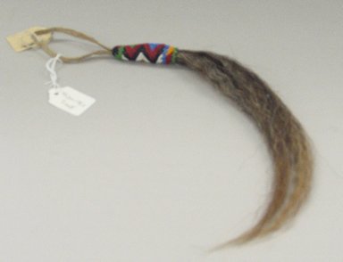 Sioux. <em>Horsehair Pendant</em>, early 20th century. Horsehair, hide, beads, approximate: 17 x 3/4 in. (43.2 x 1.9 cm). Brooklyn Museum, Anonymous gift in memory of Dr. Harlow Brooks, 43.201.178.1. Creative Commons-BY (Photo: Brooklyn Museum, CUR.43.201.178.1.jpg)