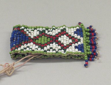 Plains. <em>One of a Pair of Tiny, Woven, Beaded Bracelets</em>, 20th century. Beads, 2 3/4 x 1 3/8 in. (7 x 3.5 cm). Brooklyn Museum, Anonymous gift in memory of Dr. Harlow Brooks, 43.201.58a. Creative Commons-BY (Photo: Brooklyn Museum, CUR.43.201.58a_view1.jpg)