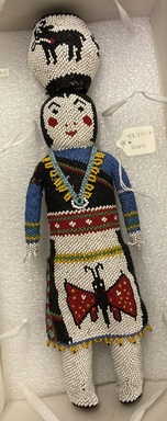 She-we-na (Zuni Pueblo). <em>Beaded Doll of woman carrying a jar</em>, early 20th century. Beads, 11 13/16 x 2 9/16in. (30 x 6.5cm). Brooklyn Museum, Anonymous gift in memory of Dr. Harlow Brooks, 43.201.7. Creative Commons-BY (Photo: Brooklyn Museum, CUR.43.201.7.jpg)