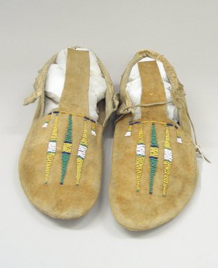 Arapaho Northern. <em>Pair of Moccasins</em>, early 20th century. Hide, beads, 10 5/8 x 3 15/16 in. (27 x 10 cm). Brooklyn Museum, Anonymous gift in memory of Dr. Harlow Brooks, 43.201.70a-b. Creative Commons-BY (Photo: Brooklyn Museum, CUR.43.201.70a-b_view3.jpg)