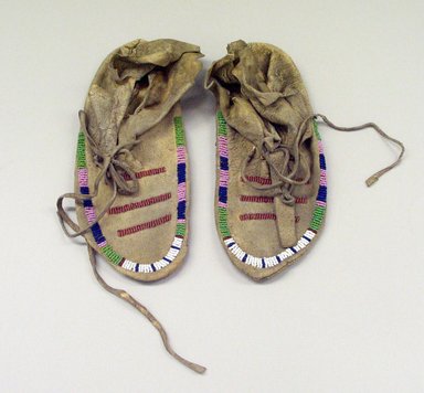 Crow. <em>Pair of Moccasins</em>, 19th century. Hide, beads, 9 1/16 x 3 15/16 in. (23 x 10 cm). Brooklyn Museum, Anonymous gift in memory of Dr. Harlow Brooks, 43.201.74a-b. Creative Commons-BY (Photo: Brooklyn Museum, CUR.43.201.74a-b.jpg)