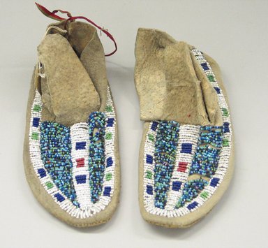 Probably Sioux. <em>Pair of Boy's Moccasins</em>, early 20th century. Rawhide, beads, 7 1/2 x 2 3/4 in. (19.1 x 7 cm). Brooklyn Museum, Anonymous gift in memory of Dr. Harlow Brooks, 43.201.76a-b. Creative Commons-BY (Photo: Brooklyn Museum, CUR.43.201.76a-b_view1.jpg)