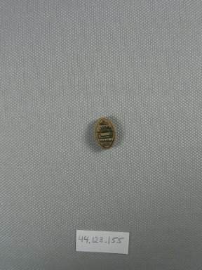 <em>Lentoid</em>. Steatite, glaze, 3/8 x 3/8 x 5/8 in. (1 x 0.9 x 1.6 cm). Brooklyn Museum, Charles Edwin Wilbour Fund, 44.123.155. Creative Commons-BY (Photo: Brooklyn Museum, CUR.44.123.155_view1.jpg)