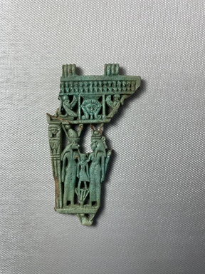  <em>Openwork Menat Fragment</em>. Faience, 3 3/4 × 2 1/8 × 1/4 in. (9.5 × 5.4 × 0.7 cm). Brooklyn Museum, Gift of Spink and Son, Ltd., 44.159.1. Creative Commons-BY (Photo: Brooklyn Museum, CUR.44.159.1_front.JPG)