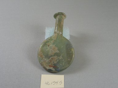 Roman. <em>Small Flask</em>, 1st-5th century C.E. Glass, 3 7/8 x greatest width 2 1/4 in. (9.9 x 5.7 cm). Brooklyn Museum, Gift of Mrs. Adrian Van Sinderen, 46.154.5. Creative Commons-BY (Photo: Brooklyn Museum, CUR.46.154.5_view1.jpg)