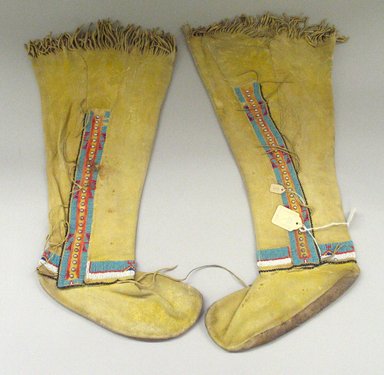 Kiowa. <em>Pair of Woman's Boots</em>, early 20th century. Buckskin, beads, pigment, nailheads, 10 x 20 in.  (25.4 x 50.8 cm). Brooklyn Museum, By exchange, 48.116.2a-b. Creative Commons-BY (Photo: Brooklyn Museum, CUR.48.116.2a-b_view1.jpg)