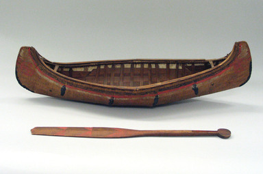Sioux. <em>Model of Dug-out Canoe and Paddle</em>, early 19th century. Cedar, pigment, canoe: 7 x 26 1/8 x 4 in. (17.8 x 66.4 x 10.2 cm). Brooklyn Museum, Henry L. Batterman Fund and the Frank Sherman Benson Fund, 50.67.64a-b. Creative Commons-BY (Photo: Brooklyn Museum, CUR.50.67.64a-b.jpg)