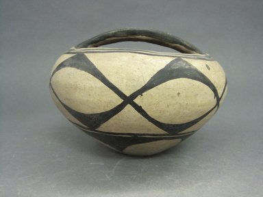 Kewa (Santo Domingo Pueblo). <em>Jar with Handle</em>, mid-20th century. Clay, slip, 4 3/4 x 6 9/16 in.  (12.0 x 16.6 cm). Brooklyn Museum, Gift of Mary E. Johnson, 51.243.11. Creative Commons-BY (Photo: Brooklyn Museum, CUR.51.243.11.jpg)