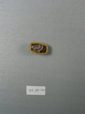  <em>One of Five Rectangular Stones</em>, ca. 410 B.C.E. Gold, agate, 3/4 x 5/16 x 7/8 in. (2 x 0.8 x 2.3 cm). Brooklyn Museum, Charles Edwin Wilbour Fund, 54.50.16. Creative Commons-BY (Photo: Brooklyn Museum, CUR.54.50.16_view1.jpg)
