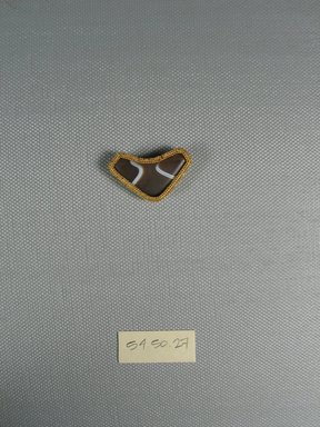  <em>One of Eleven Triangular Stones</em>, ca. 410 B.C.E. Gold, agate, 11/16 x 1/4 x 1 1/4 in. (1.7 x 0.6 x 3.2 cm). Brooklyn Museum, Charles Edwin Wilbour Fund, 54.50.27. Creative Commons-BY (Photo: Brooklyn Museum, CUR.54.50.27_view1.jpg)