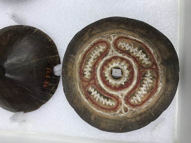  <em>Breast Plate</em>. Coconut shell, pigment, diameter: 4 7/16 in. (11.2 cm). Brooklyn Museum, Gift of Arturo and Paul Peralta-Ramos, 56.6.103. Creative Commons-BY (Photo: , CUR.56.6.103.jpg)