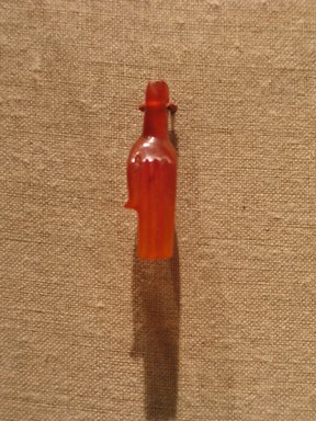  <em>Hand Amulet</em>, ca. 1332–1322 B.C.E. Carnelian, 1 3/16 x 1/16in. (3 x 0.1cm). Brooklyn Museum, Anonymous gift in memory of Arthur W. Clement, 57.76.1. Creative Commons-BY (Photo: Brooklyn Museum, CUR.57.76.1_wwgA-3.jpg)