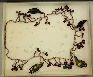 Possibly Maina. <em>Necklace</em>, 20th century. Seeds, whole birds, plant fiber, 19 1/2 × 2 × 24 7/8 in. (49.5 × 5.1 × 63.2 cm), measured in box. Brooklyn Museum, Gift of George Grossblatt, 58.159.10. Creative Commons-BY (Photo: Brooklyn Museum, CUR.58.159.10.jpg)